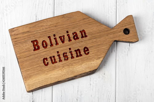 Wooden cutting board with inscription. Concept of bolivian cuisine photo