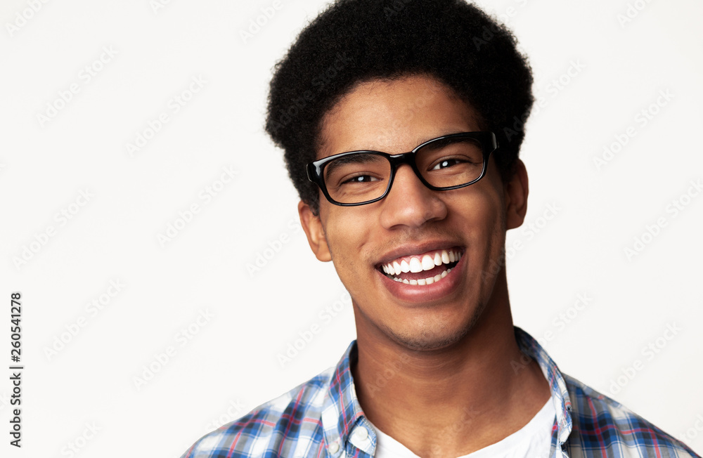 Portrait of student wearing glasses, light background