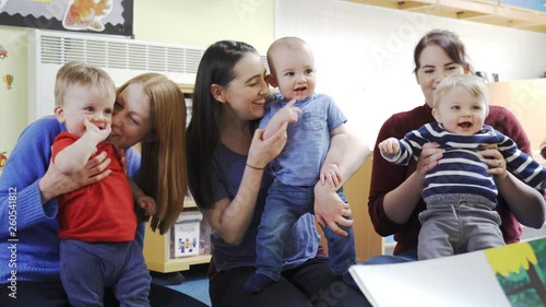Mothers With Children At Baby Group Listening To Story