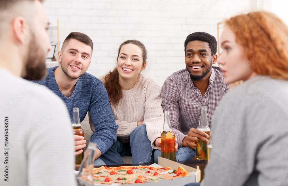 Friends meet together. Students eating pizza and talking Friends meet together. Students eating pizza and talking