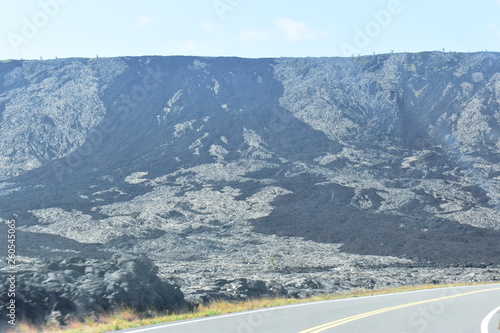 Old hardened lava flow going down a mountain toward the coast. © Justin