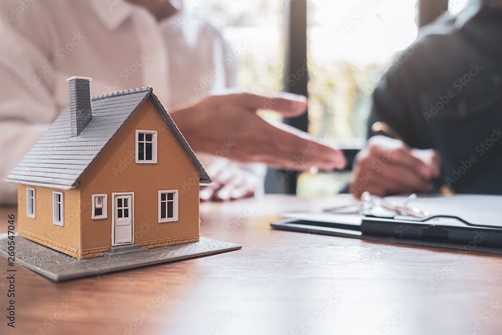 Fototapeta premium Car and House model with agent and customer discussing for contract to buy, get insurance or loan real estate or property background.