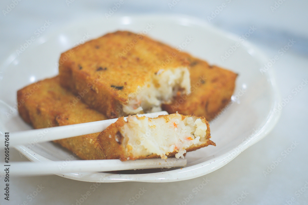 three pieces of deep fried carrot cake with real carrot bits inside