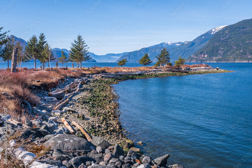 Naklejka premium Fantastic view over ocean, snow mountain and rocks at Burrard inlet in Vancouver, Canada.