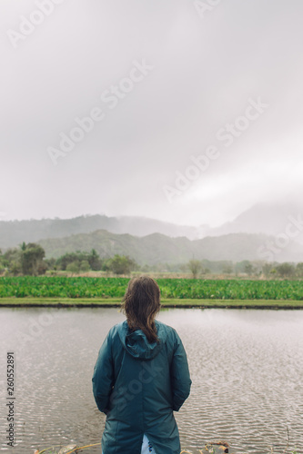 Woman standing with her hand in the pocket on Taro farm in Kauai
