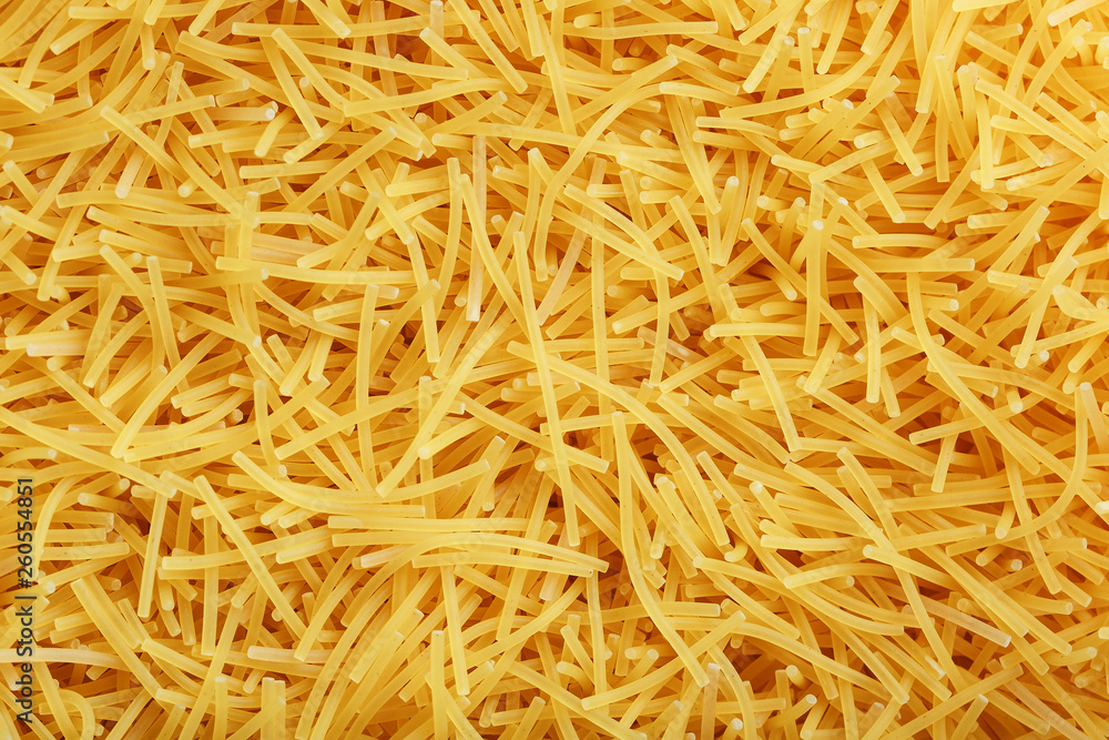 Background texture and pattern of boiled egg noodles or spaghetti pasta in full-frame format. View from above. Close-up