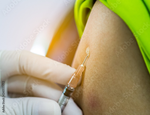 Hand of doctor inject vaccine solution in intradermal photo