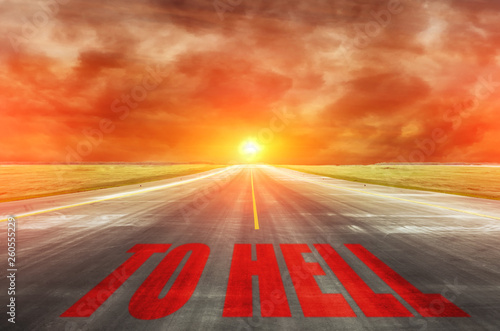фотографія The road with inscription leading straight to the devil to hell.