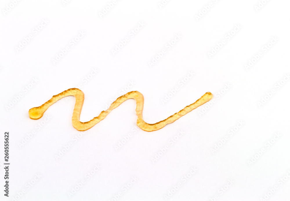 Close up spiral curve of orange liniment gel isolated on white background. Close up spiral curve of orange liniment gel isolated on white background.