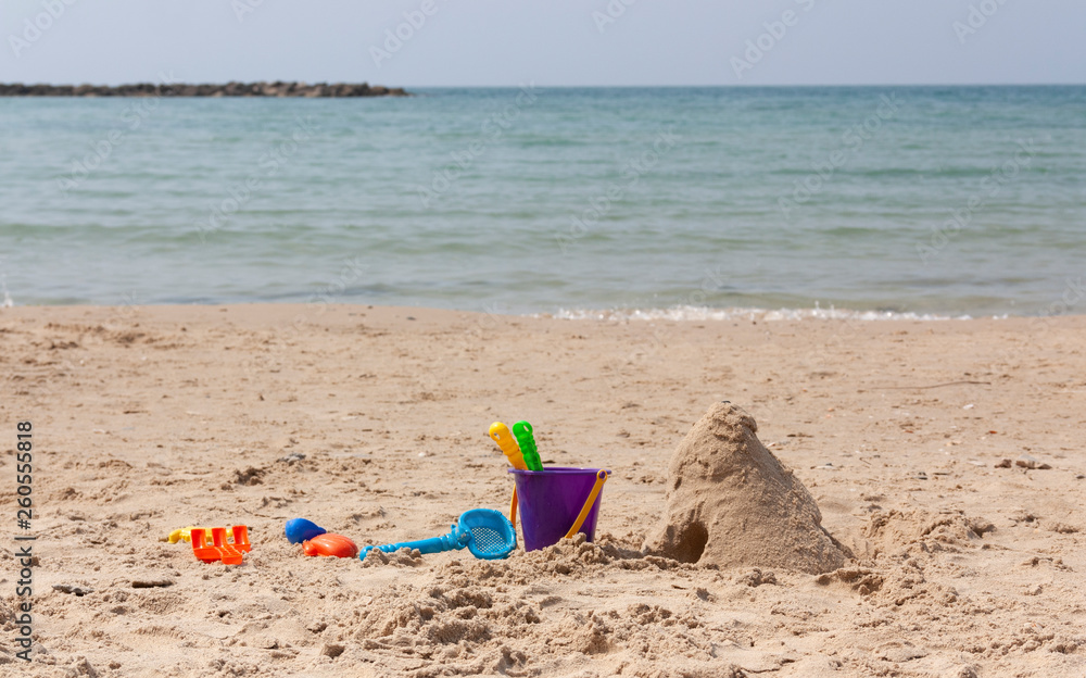 children's shovels in the sand on the beach children's shovels in the sand on the beach