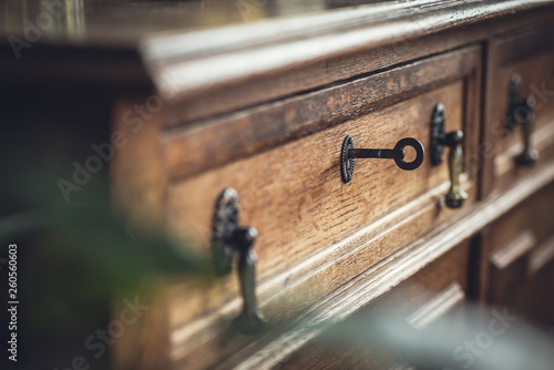Vintage. Old chest of drawers with a key in the keyhole. Shallow DOF