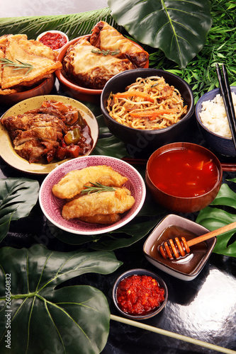 Assorted Chinese food set. Chinese noodles, fried rice, peking duck, dim sum, spring rolls. Famous Chinese cuisine dishes on table. Chinese restaurant