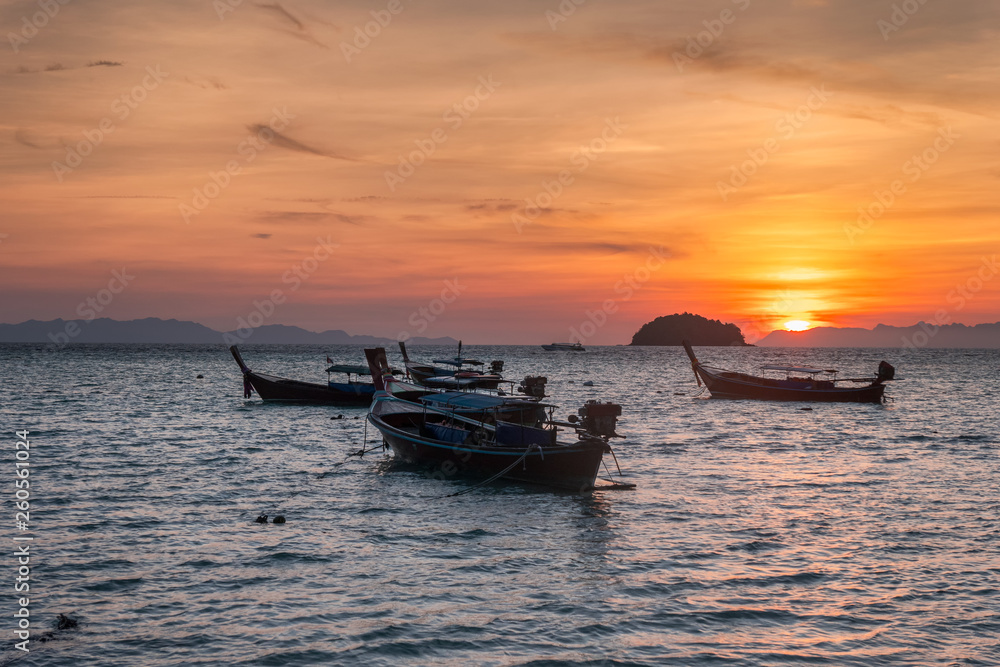 Wooden long-tail boats on tropical sea at sunrise morning