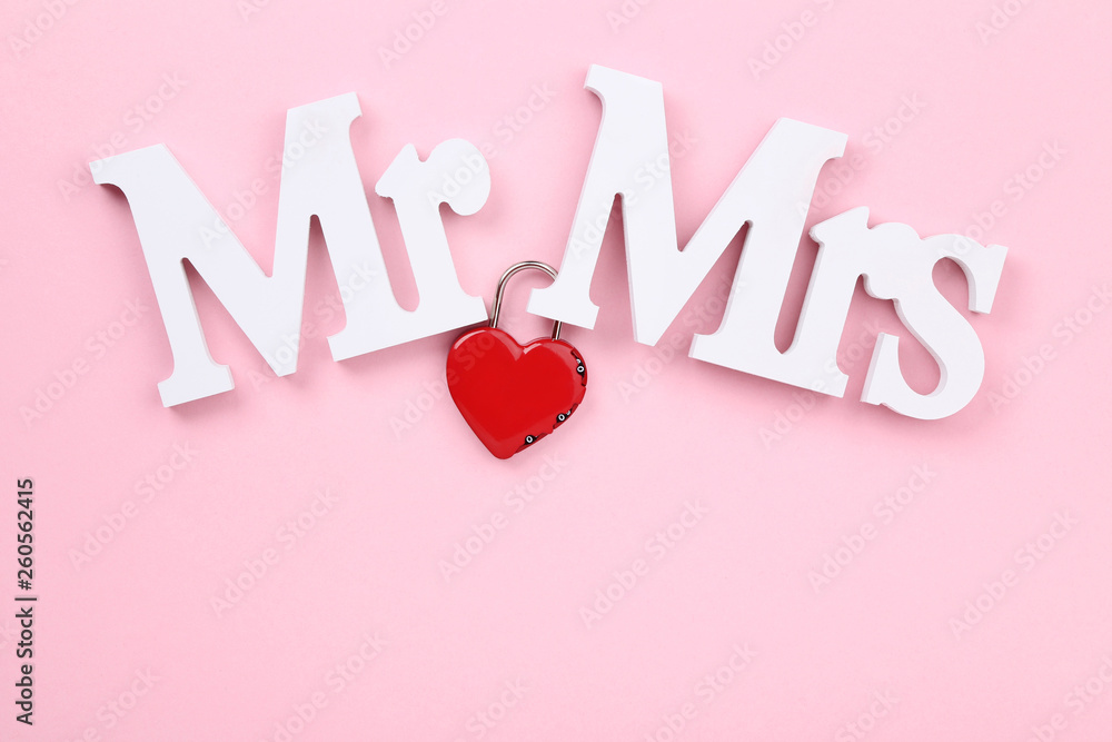 White letters Mr and Mrs with red heart on pink background