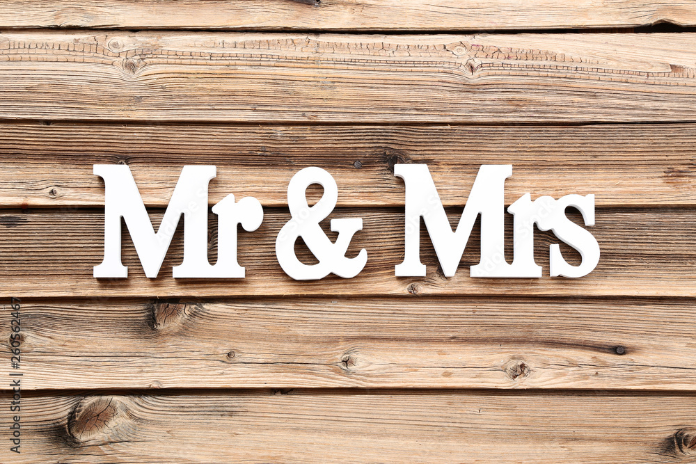White letters Mr and Mrs on brown wooden table White letters Mr and Mrs on brown wooden table