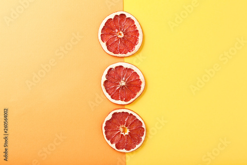 Dried grapefruits on colorful background