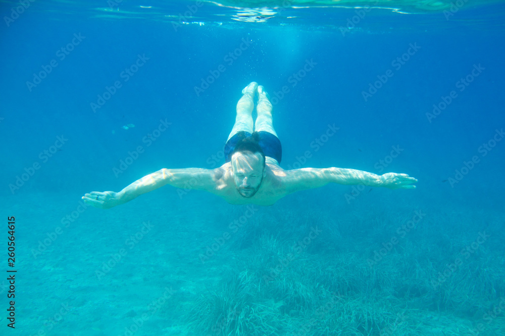 Man diving swimming underwater view