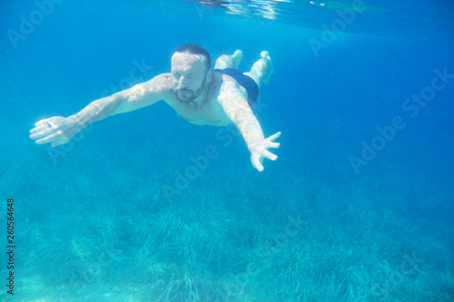 Man diving swimming underwater view