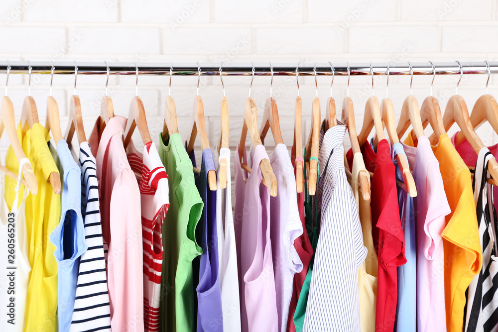 Fashion clothes hanging on brick wall background Fashion clothes hanging on brick wall background