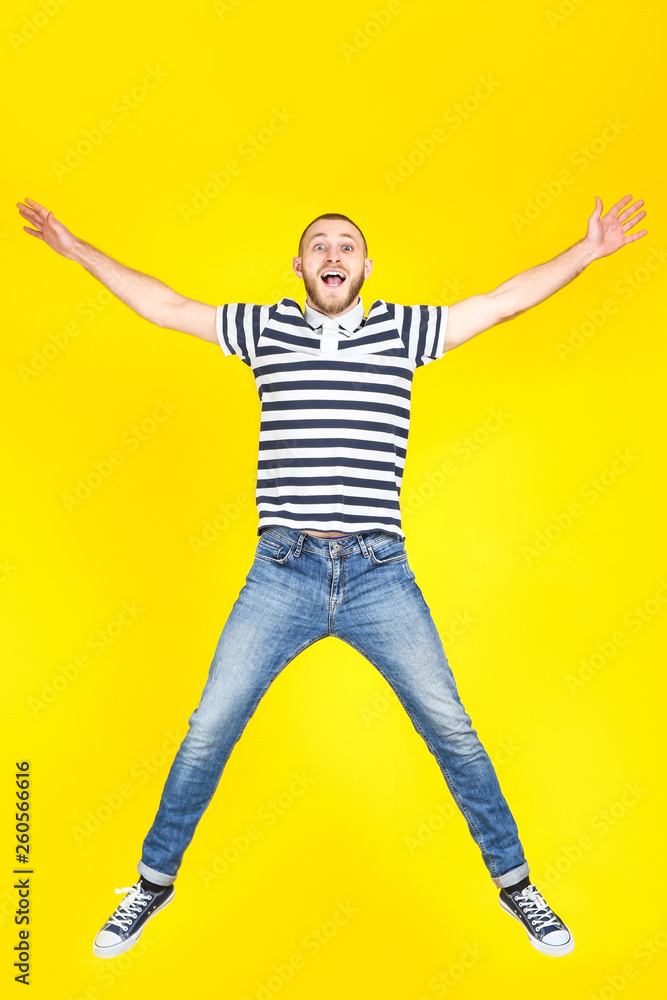 Obraz premium Jumping young man on yellow background