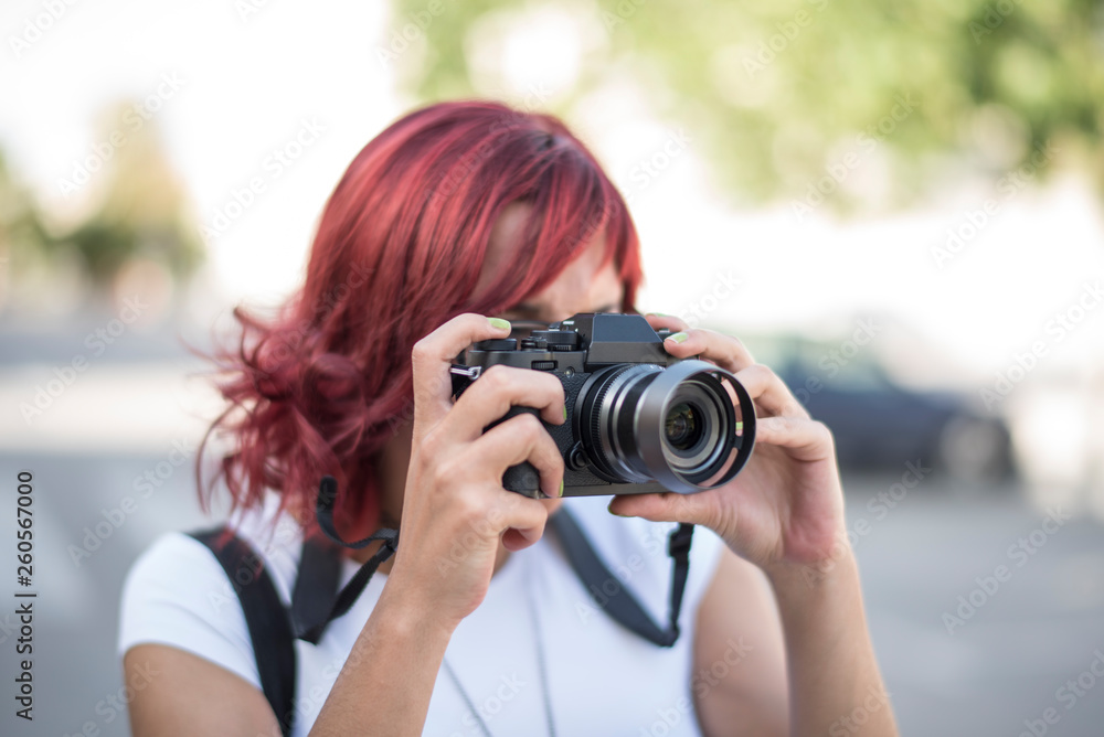 woman taking photo with mirroless camera