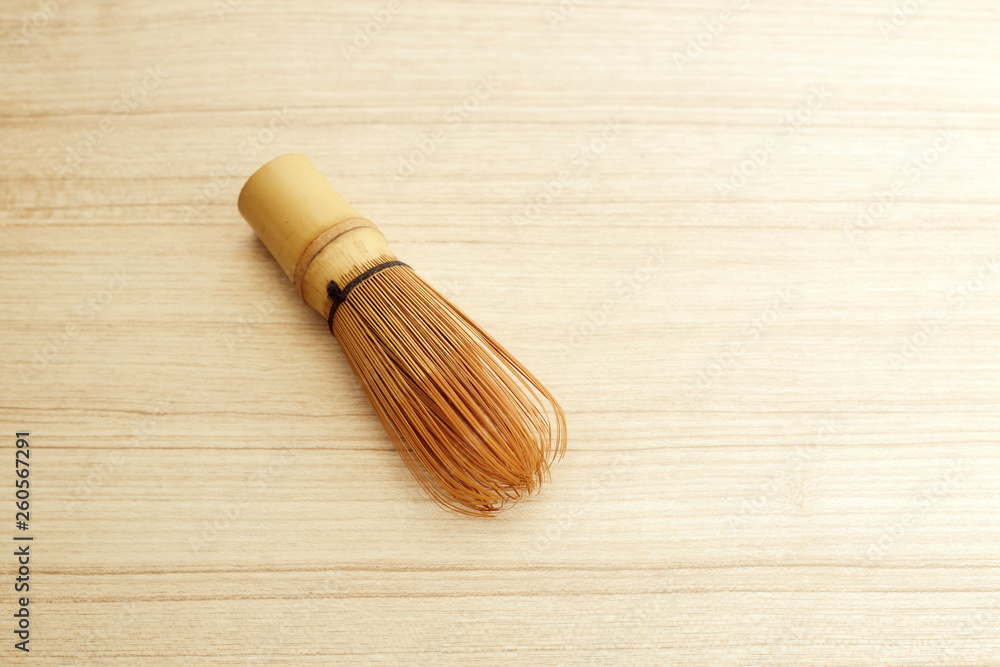 Bamboo tea whisk for matcha on wooden table