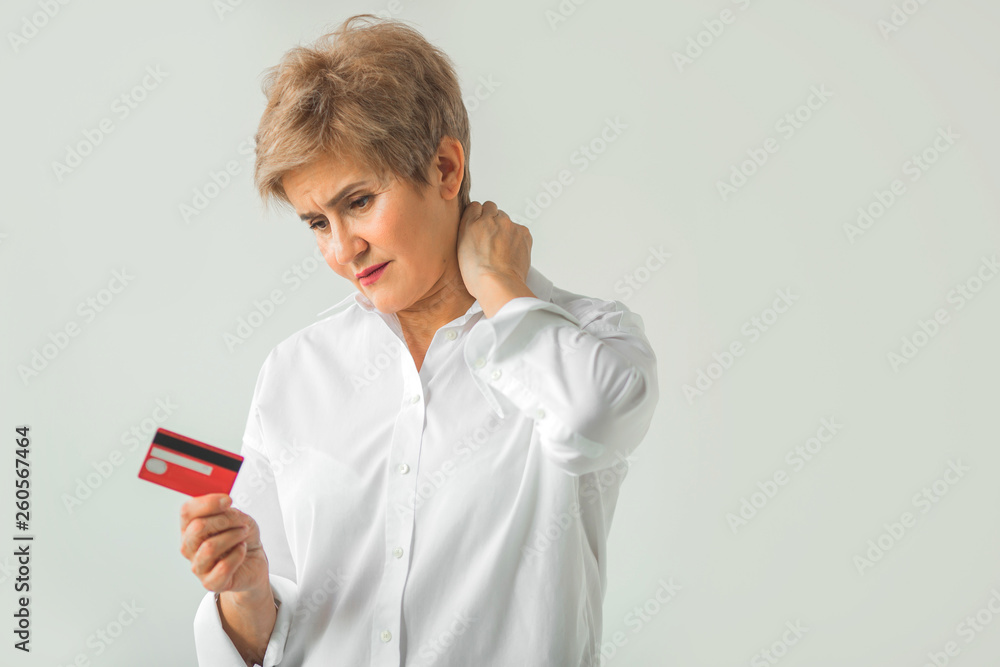adult stylish woman in a white shirt on a white background with a credit card in hand adult stylish woman in a white shirt on a white background with a credit card in hand