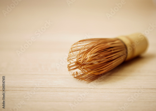 Bamboo tea whisk for matcha on wooden table