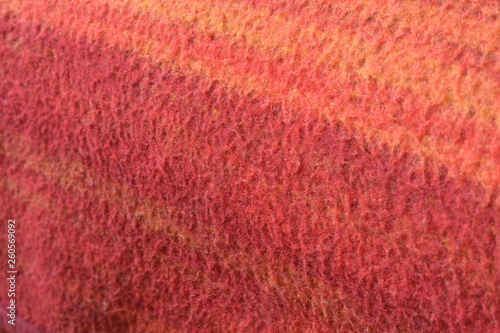 a woolen blanket with a red and orange pattern