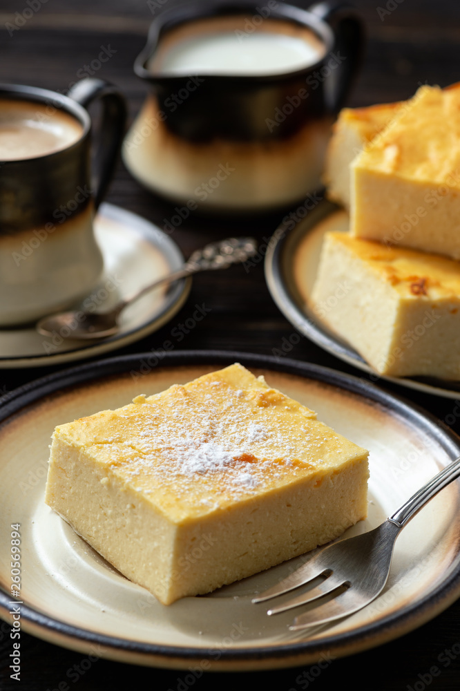 Homemade sliced cheesecake and the cup of coffee. 