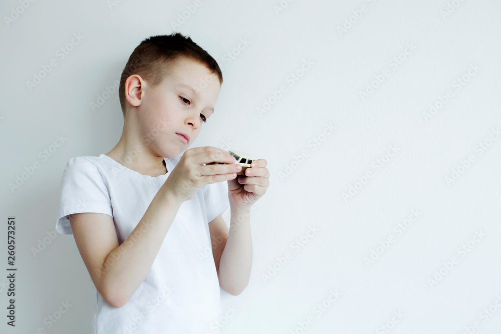 the child holds a car in his hands and look dreamily at him. Dream about car concept the child holds a car in his hands and look dreamily at him. Dream about car concept