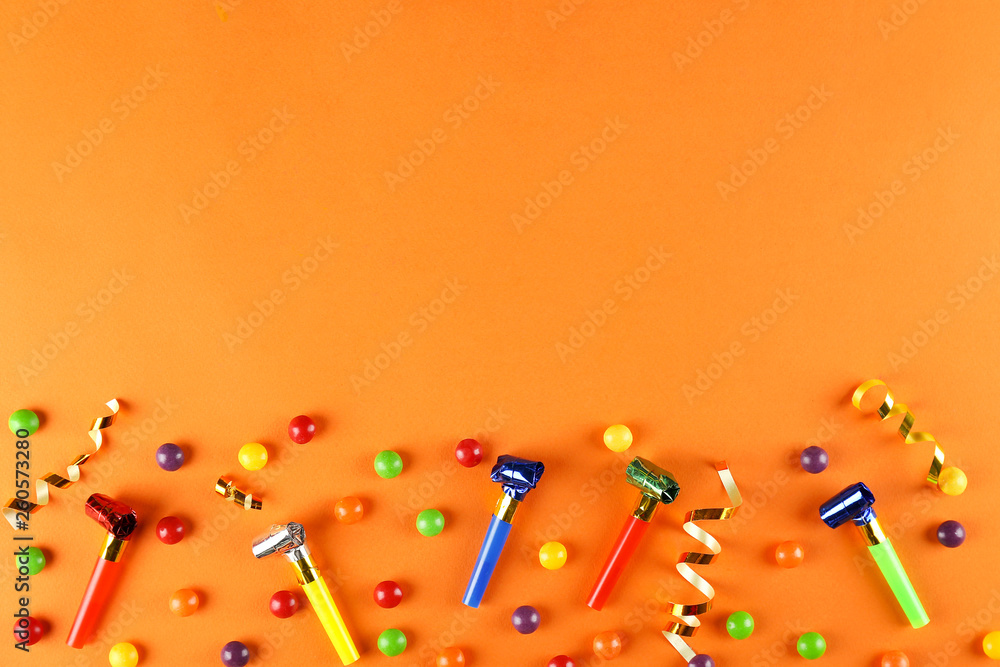 Birthday party traditional accessories and celebration attributes on bright paper textured background. Close up, top view, copy space, flat lay. Birthday party traditional accessories and celebration attributes on bright paper textured background. Close up, top view, copy space, flat lay.