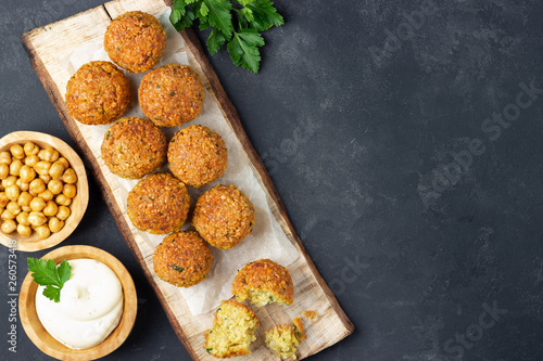 Overhead image of arabic snack falafel in the form of chickpea balls with spices. Dark slate background.