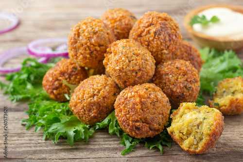 Vegetarian dish - falafel balls from spiced chickpeas on wooden rustic table. photo