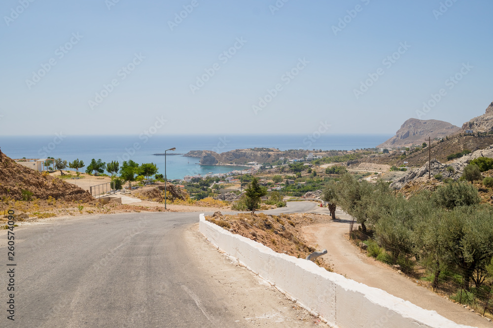 Road and Natural Landscape.Empty mountain asphalt road in Corfu island, Greece. Wide angle lens shot.Empty asphalt road highway in the forested mountains.Carefree driving on a bright sunny day.