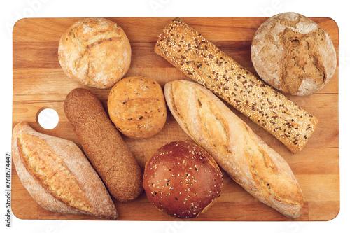 different types of bread on wooden kitchen cutting board