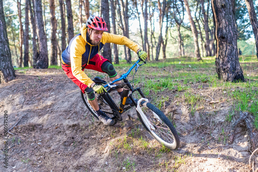 Cycling, a cyclist in bright clothes riding a mountain bike on the edge of a cliff. Active lifestyle. Cycling, a cyclist in bright clothes riding a mountain bike on the edge of a cliff. Active lifestyle.