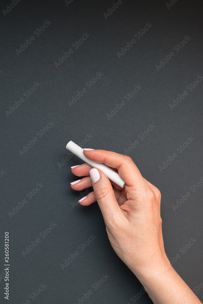 Teacher hand with piece of chalk Teacher hand with piece of chalk
