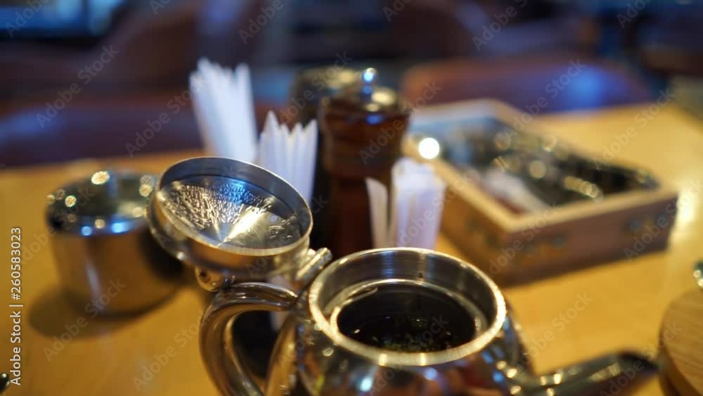 metal tea pot and cutlery set in wooden box on table metal tea pot and cutlery set in wooden box on table