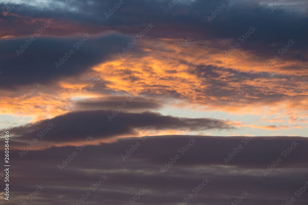Dramatic evening sky backgound. Golden sunset heaven. Scenic sky with clouds in dust. Twilight concept. Colorful cloudscape. Beautiful dawn background. Space and peace concept.