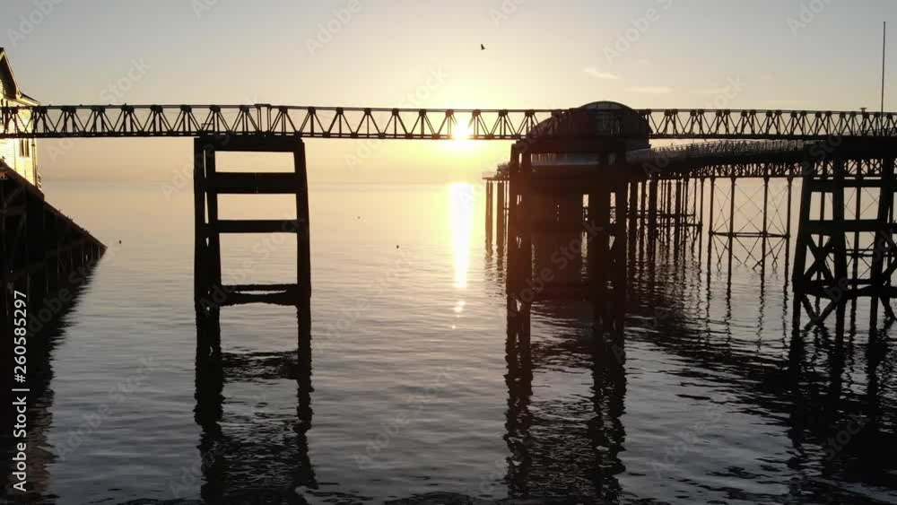 Gower lifeboat center sunrise under pier Gower lifeboat center sunrise under pier