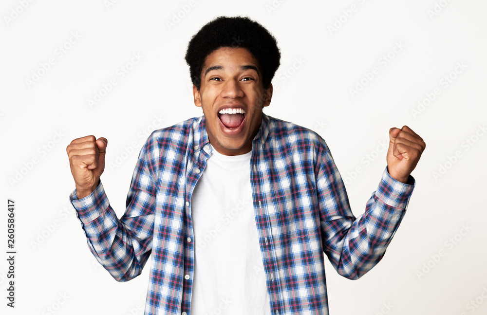 Fototapeta premium Yes, I did it! Guy celebrating victory over white background