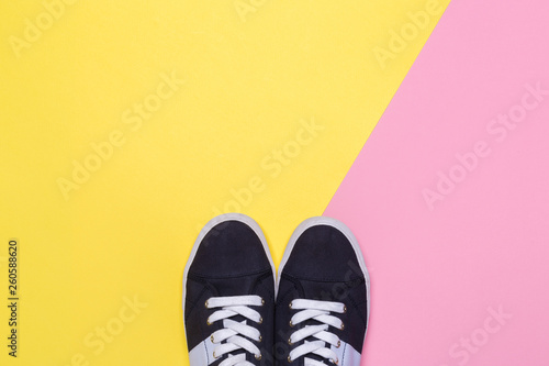 Sneakers on pink and yellow background. Fashion blog or magazine concept.