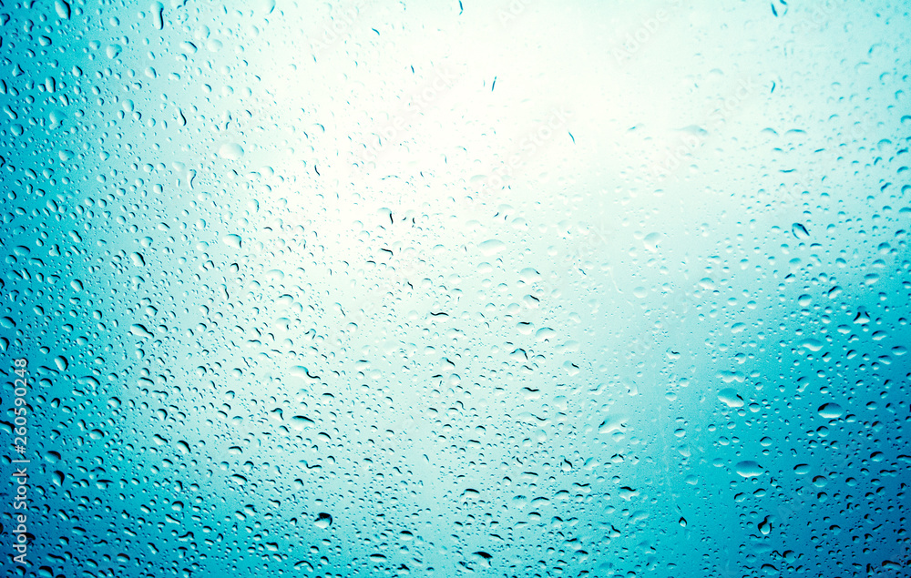 water drops on blue background / Drops of rain on glass , rain drops on clear window / Blue Abstract Water Drops Background / water drops on glass surface as background.