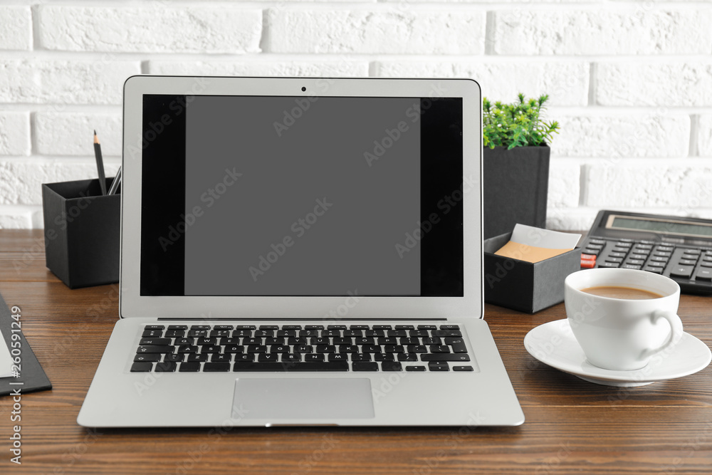 Modern laptop with blank screen on table. Space for design Modern laptop with blank screen on table. Space for design