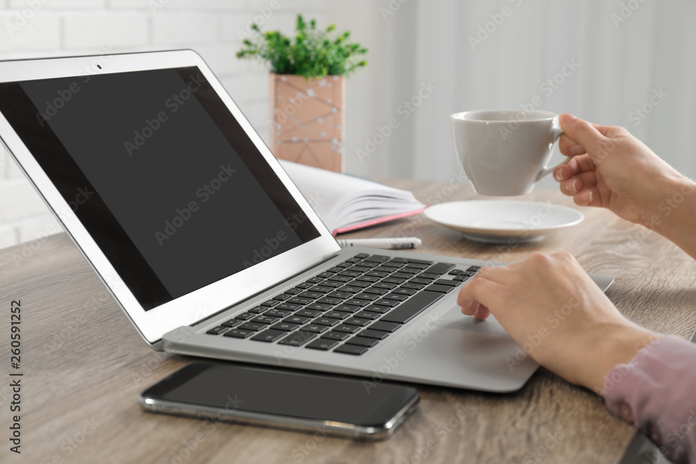 Woman working with laptop at table, closeup. Space for design Woman working with laptop at table, closeup. Space for design