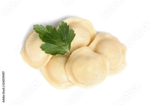 Boiled dumplings with parsley on white background, top view