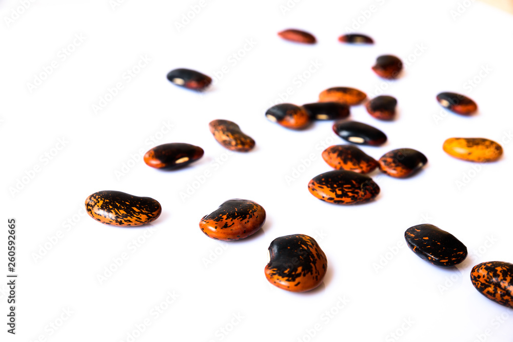 a few of black-brown beans on white background a few of black-brown beans on white background