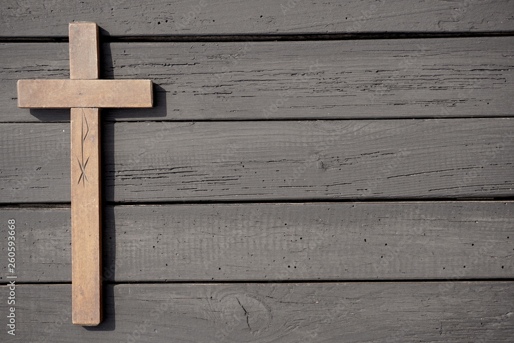 Christian cross on the wooden table 