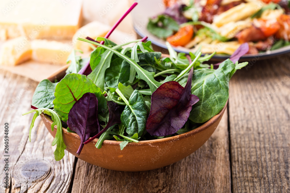 Fresh salad in ceramic bowl, healthy plant-based meal Fresh salad in ceramic bowl, healthy plant-based meal